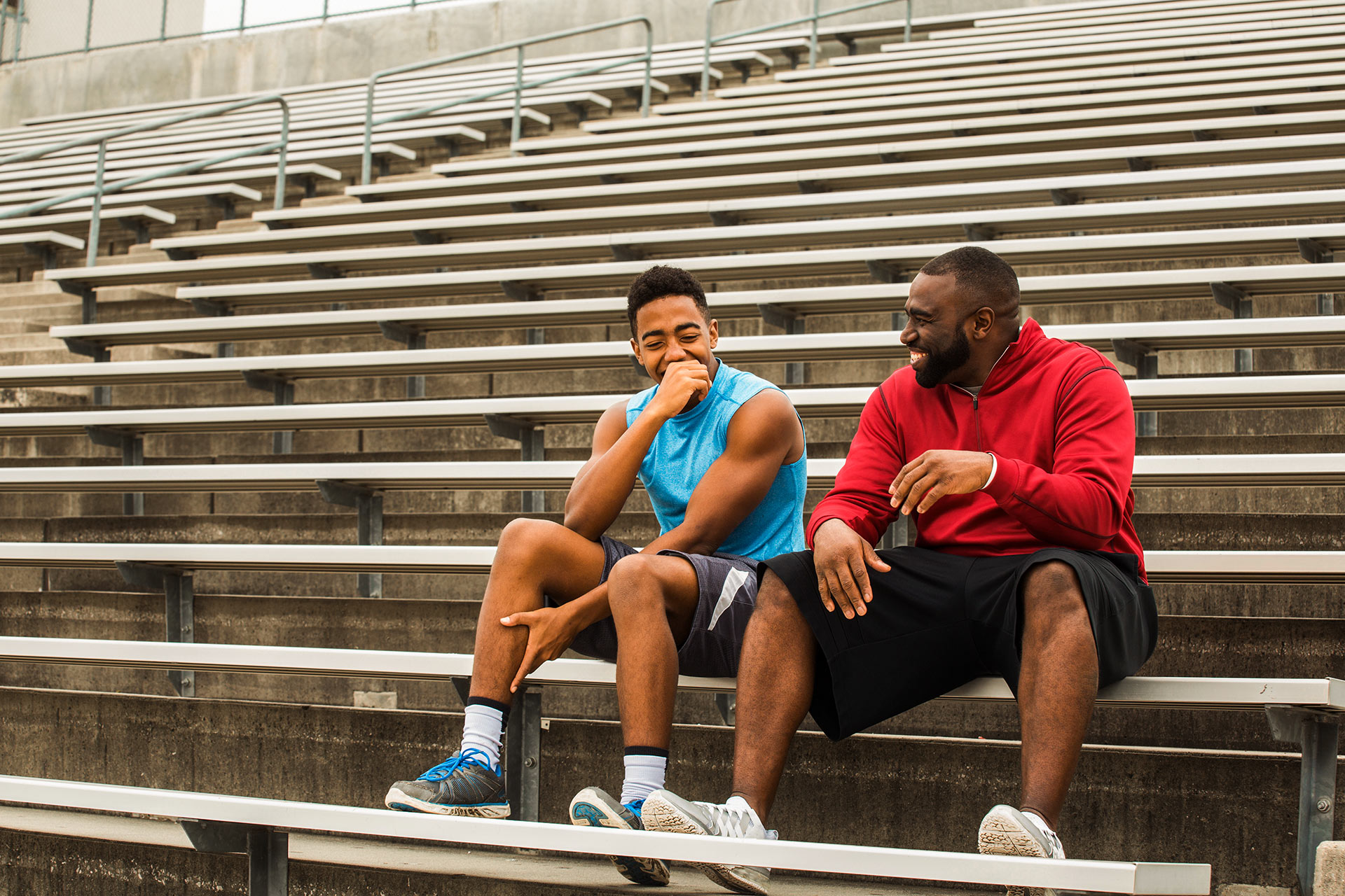 A christian mentor having a 1 to 1 with a student after playing basketball together.